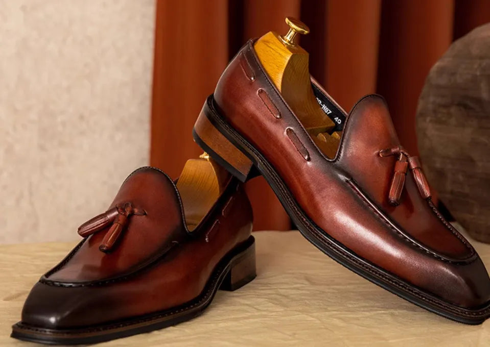 Men's genuine leather slip-on loafers with fringed detailing in black or brown