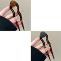 Acrylic U-shaped hair barrette with a small spherical decoration in a beige and caramel two-tone colour combination.