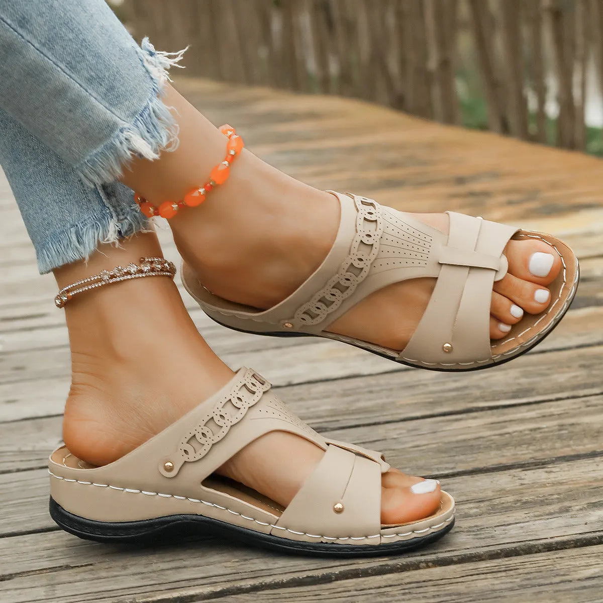 Pair of blue Roman-style slope heel slippers showing fish mouth toe holder design.