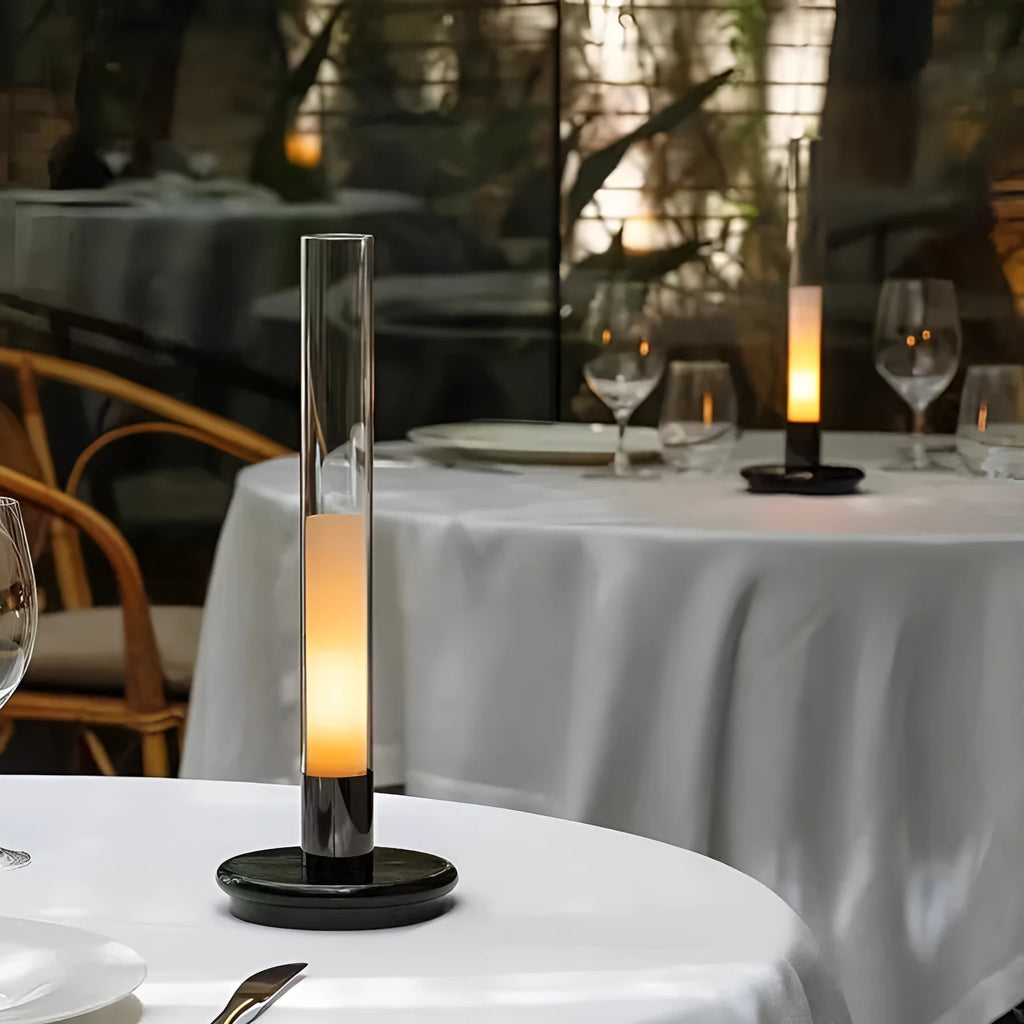 Black Nordic style LED table lamp with three-colour lighting modes on a desk