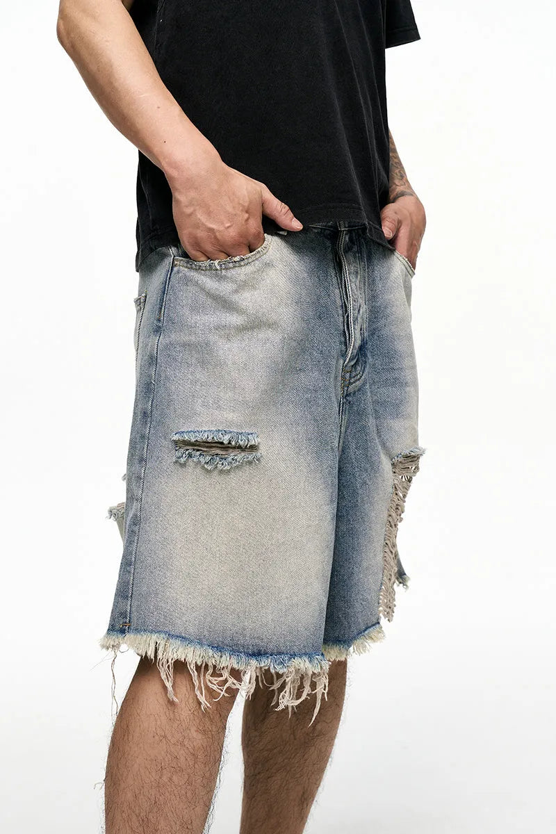 Light blue men's baggy retro denim shorts on a mid waist, showing wide leg and fifth pants length