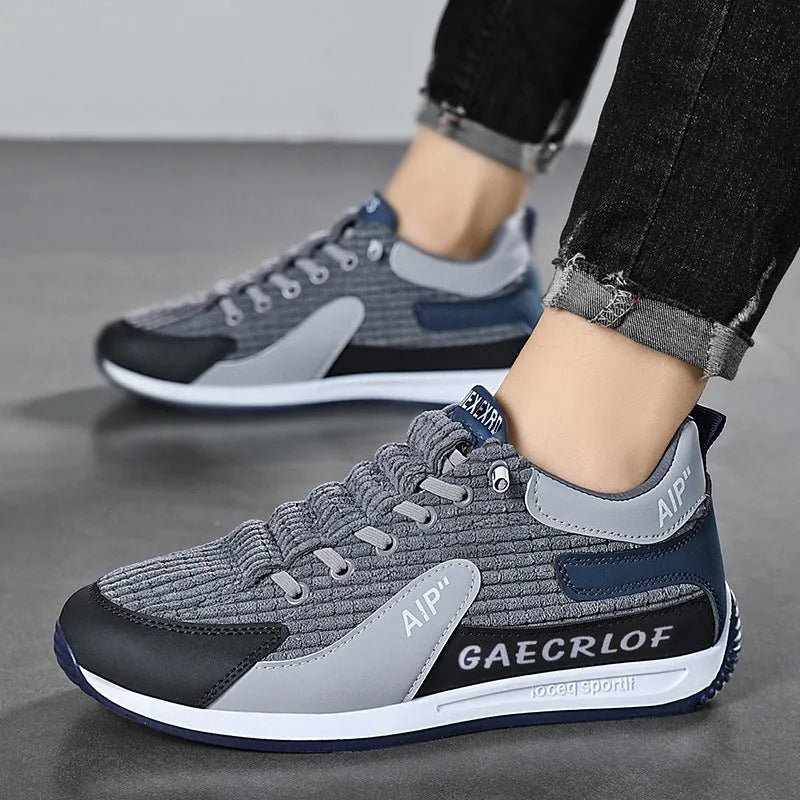 Men's grey and green mesh sports trainers with lace-up front and round toe.