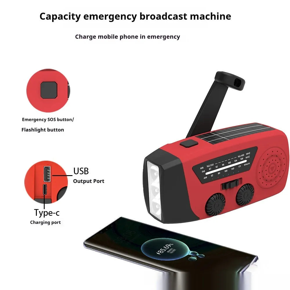Red rechargeable hand-held radio with emergency torch, USB port, speaker, and wrist strap.