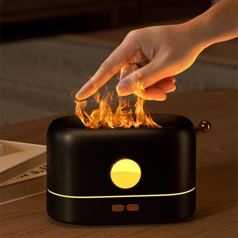 Black desktop humidifier with flame effect light and mist output, showing USB port and water tank.