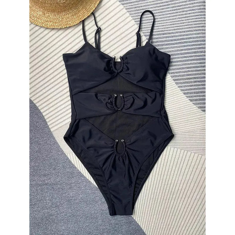 Black women's one-piece swimsuit on hanger showing form-fitting nylon design