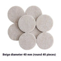 Assortment of beige plastic furniture leg protector pads in round and square shapes on a floor