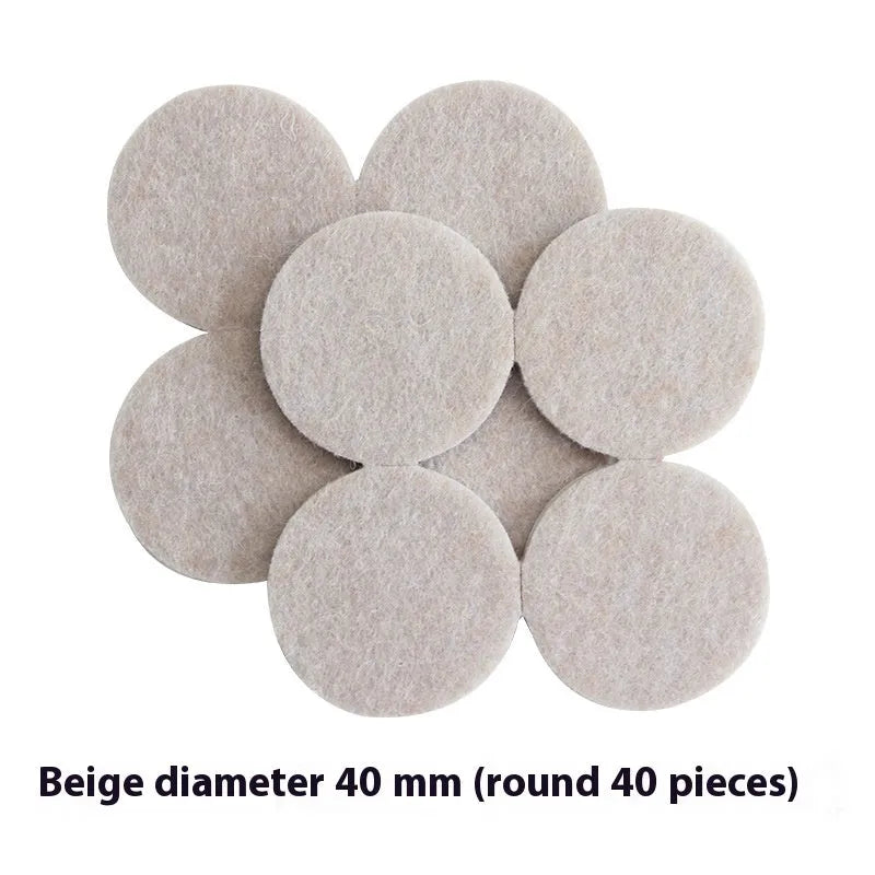 Assortment of beige plastic furniture leg protector pads in round and square shapes on a floor