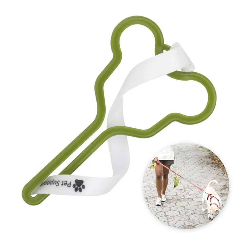 A black dog poop bag holder with a fixed clip and velcro strap, shown attached to a dog leash.