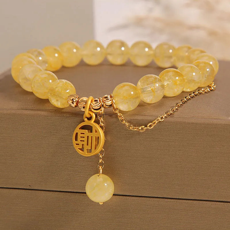 Natural stone citrine bracelet with Chinese character tassel in either Cai or Fu design