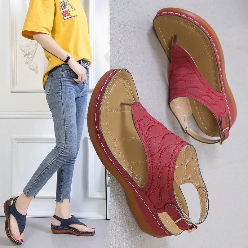 Women's wedge heel sandal in a solid colour with an adjustable back strap buckle.