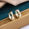 Geometric copper earrings with 14K yellow zircon stone accents showing simple wild aesthetic design