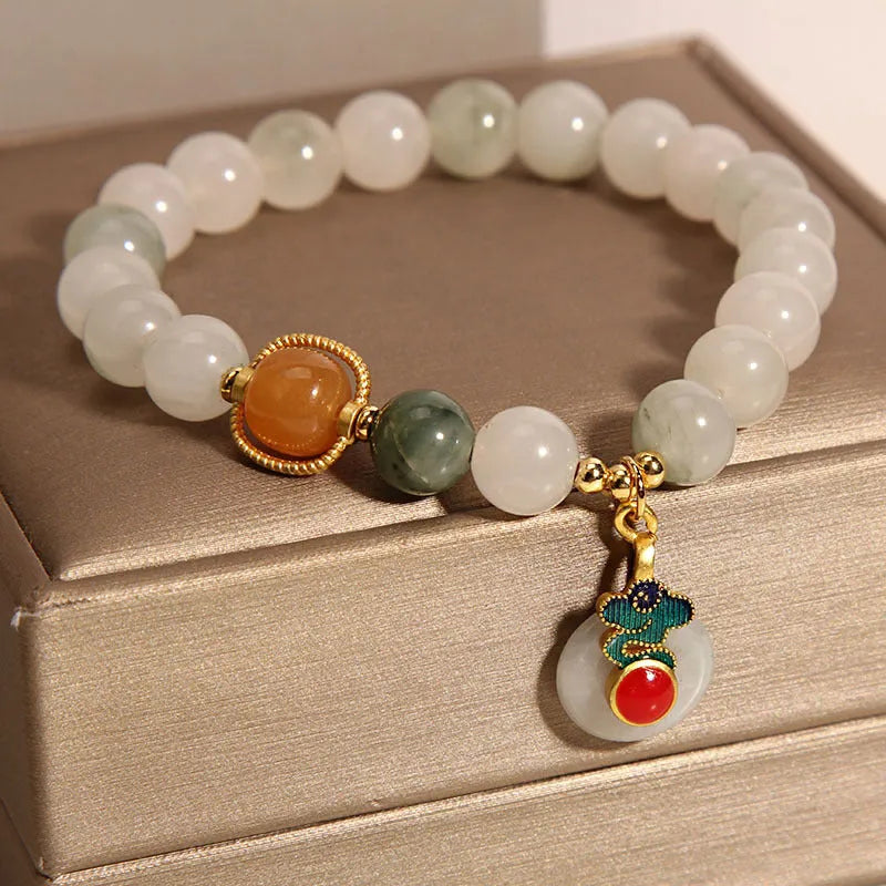 Women's ice jade crystal bracelet with Xiangyun peace buckle and pearl details.