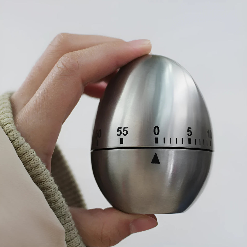 Stainless steel mechanical kitchen timer with egg shape measuring 7cm high