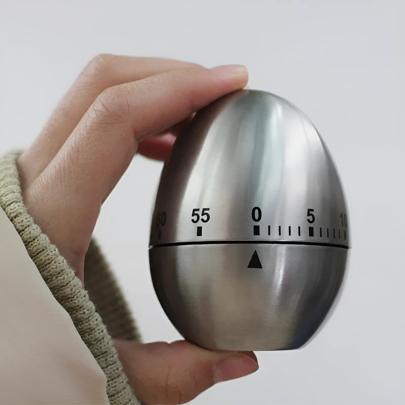 Stainless steel mechanical kitchen timer with egg shape measuring 7cm high