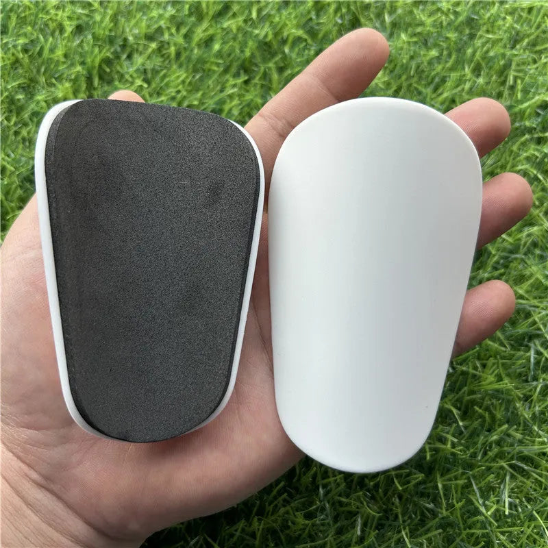 Black and white extra small plastic football shin guards for junior players