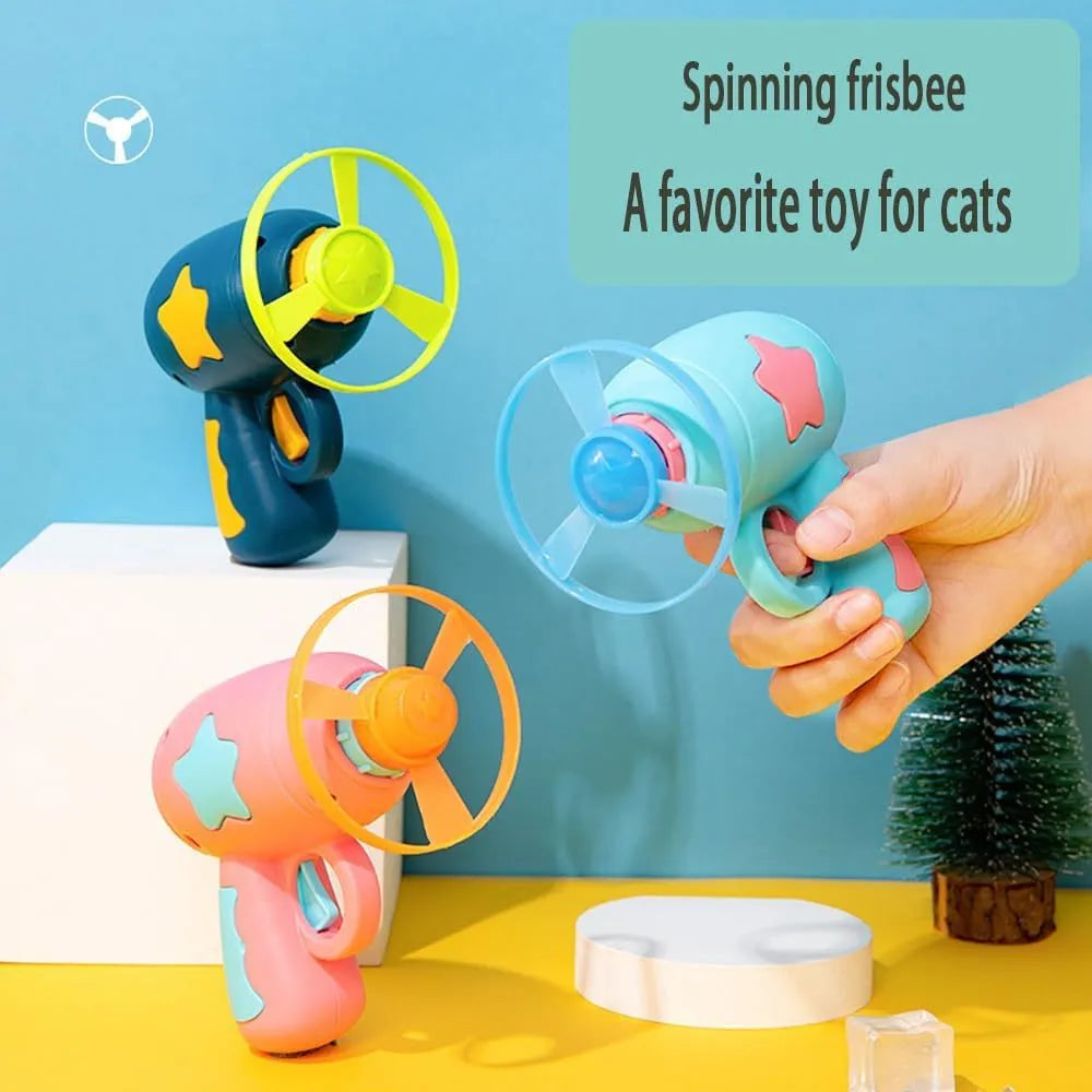 Blue plastic cat toy gun with spinning Frisbee disc for indoor cat play