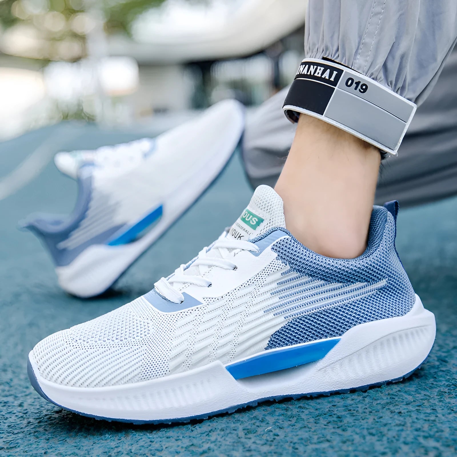 Men's blue casual sports mesh shoes with round toe and cloth upper on a plain background.