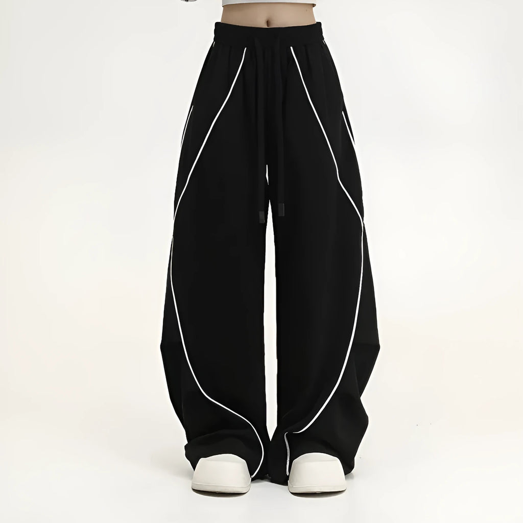 Black and grey striped men's wide-leg pleated sports pants on a hanger.