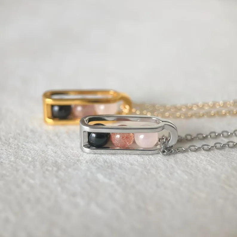 Minority simple pearl necklace in titanium steel with inlaid pearl, shown in gold or silver steel colour.