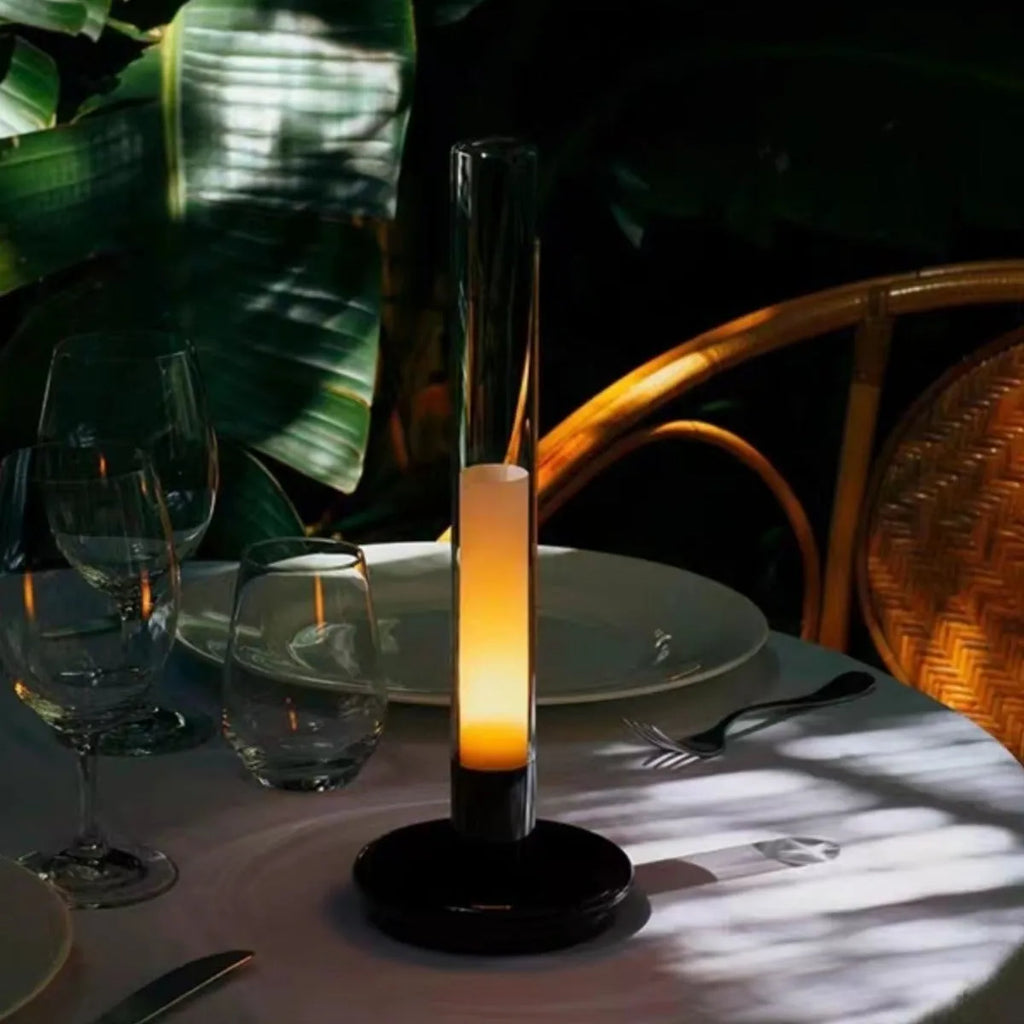 Black Nordic style LED table lamp with three-colour lighting modes on a desk