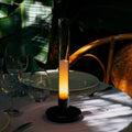 Black Nordic style LED table lamp with three-colour lighting modes on a desk
