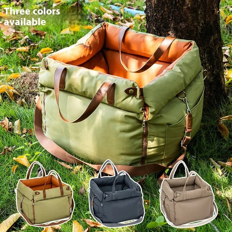 Brown cloth portable cat car kennel with mesh windows, shown on a car seat.