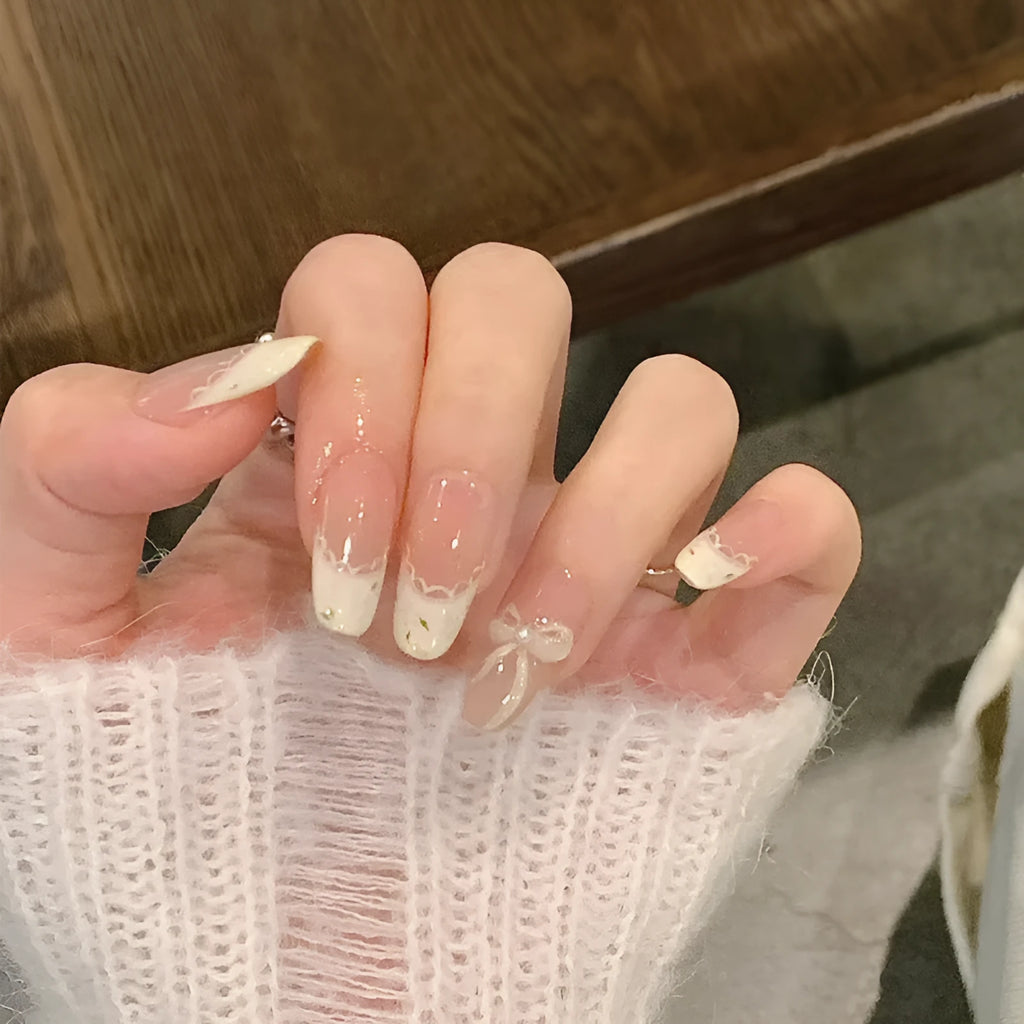 Pack of sweet pastel coloured press-on false nails for girls on a pink background.