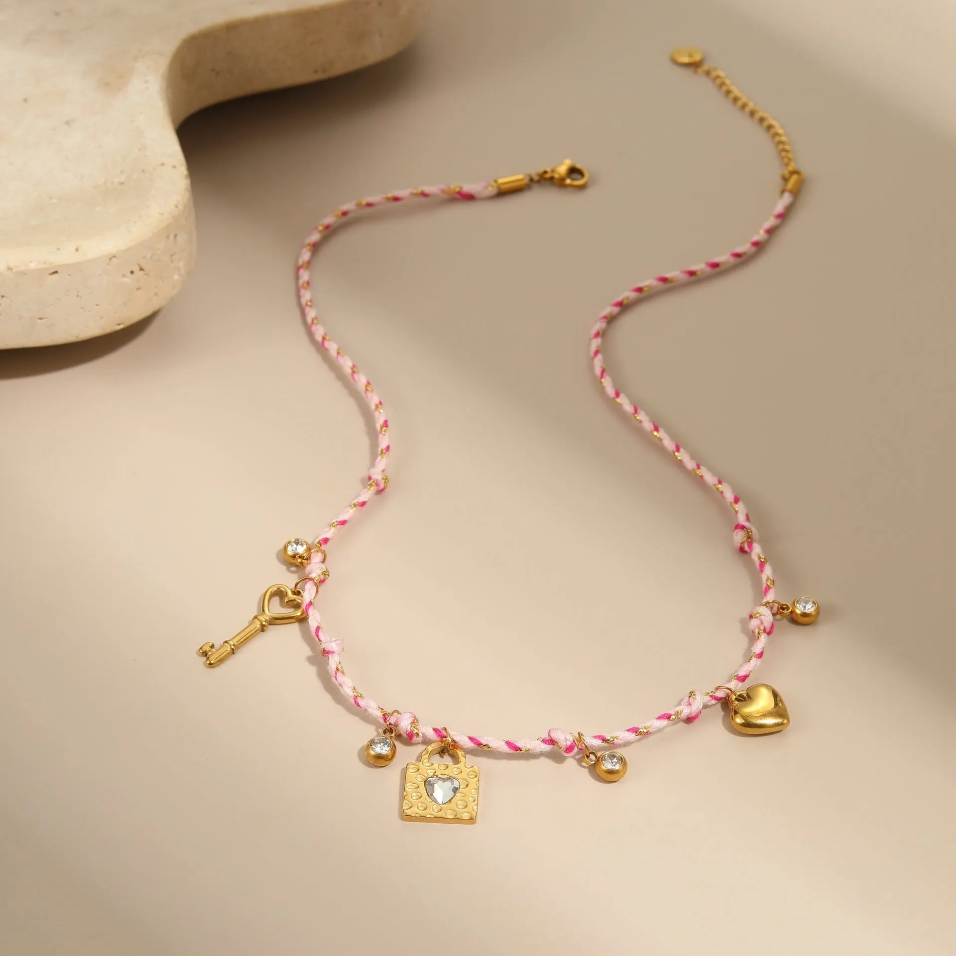 Handmade stainless steel necklace with coloured braided rope detail and geometric pendant
