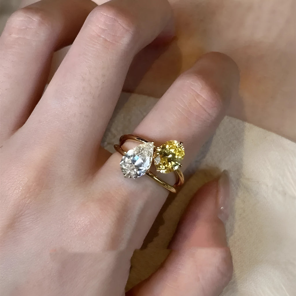 Women's copper open ring with geometric shape and water drop double sheng stone centre.
