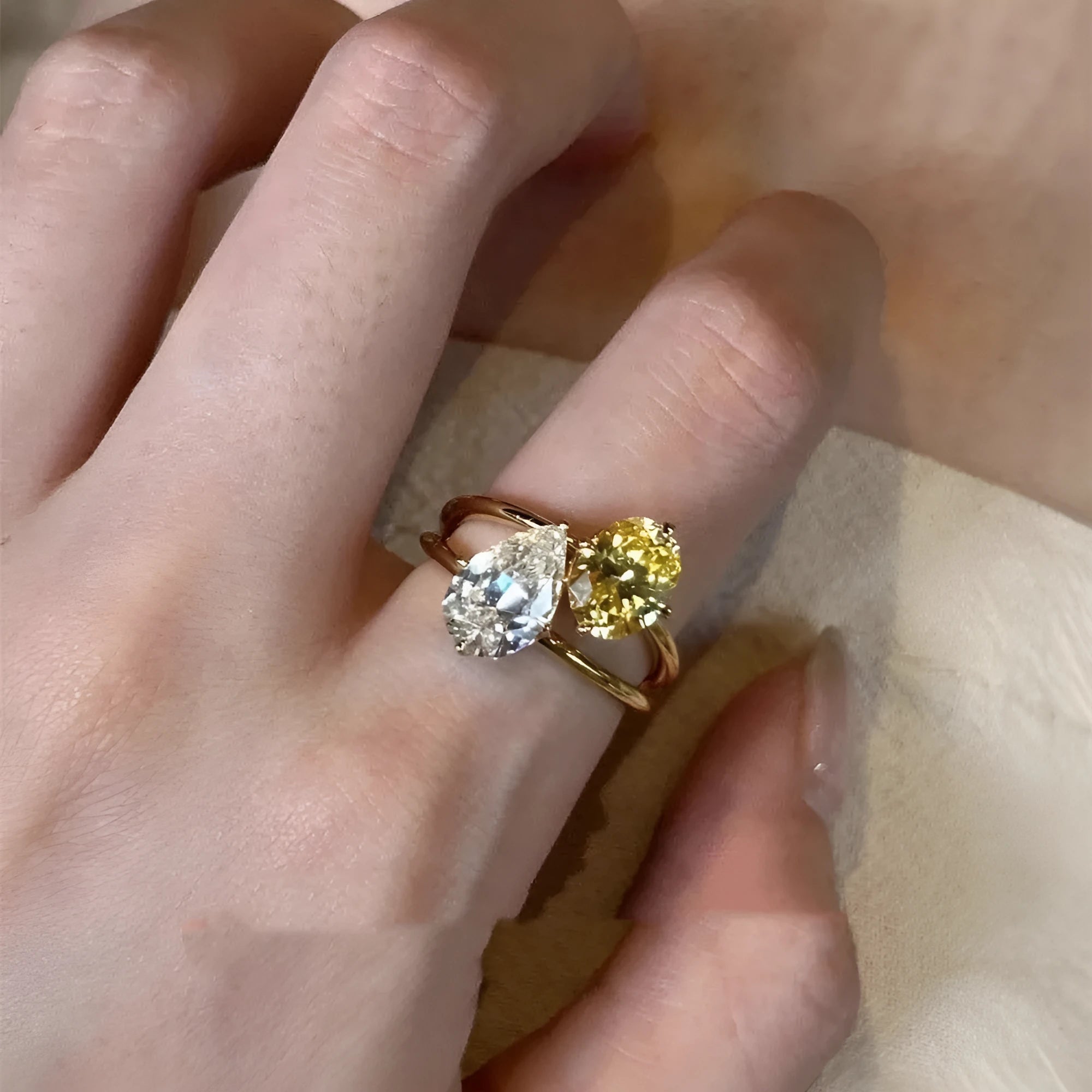 Women's copper open ring with geometric shape and water drop double sheng stone centre.