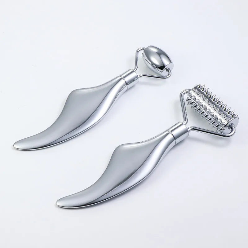 Stainless steel double-headed facial roller, heart-shaped acupressure stick, and scraping plate on a white background.