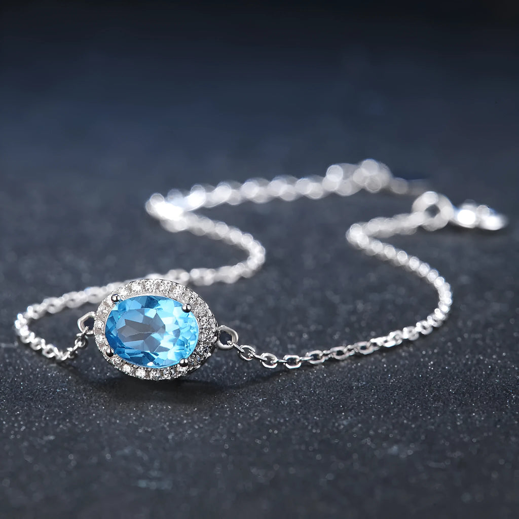 925 sterling silver jewellery set with blue topaz stones showing earrings, ring, pendant and necklace in geometric design