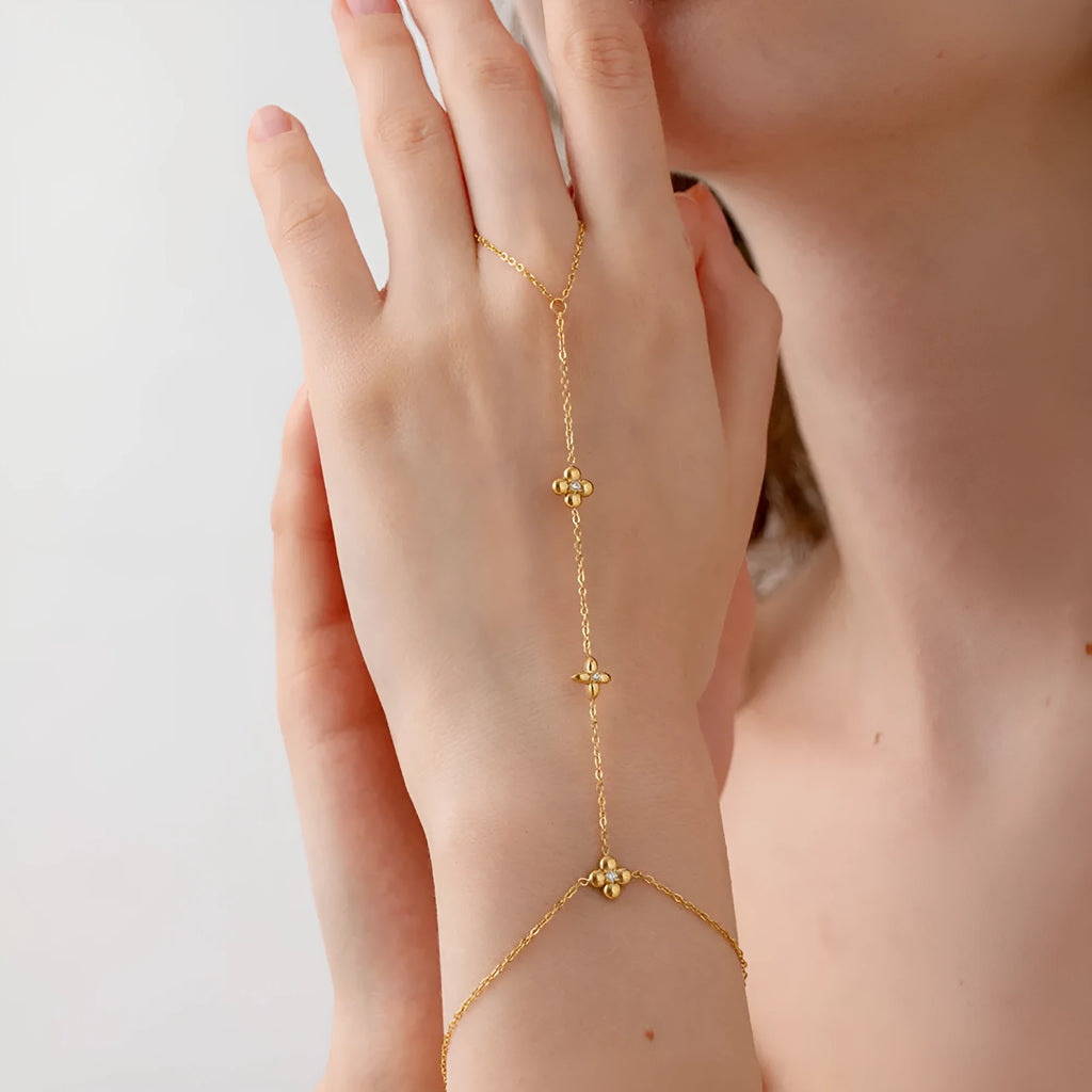 Gold-coloured stainless steel women's bracelet with geometric floral and eight-pointed star design.