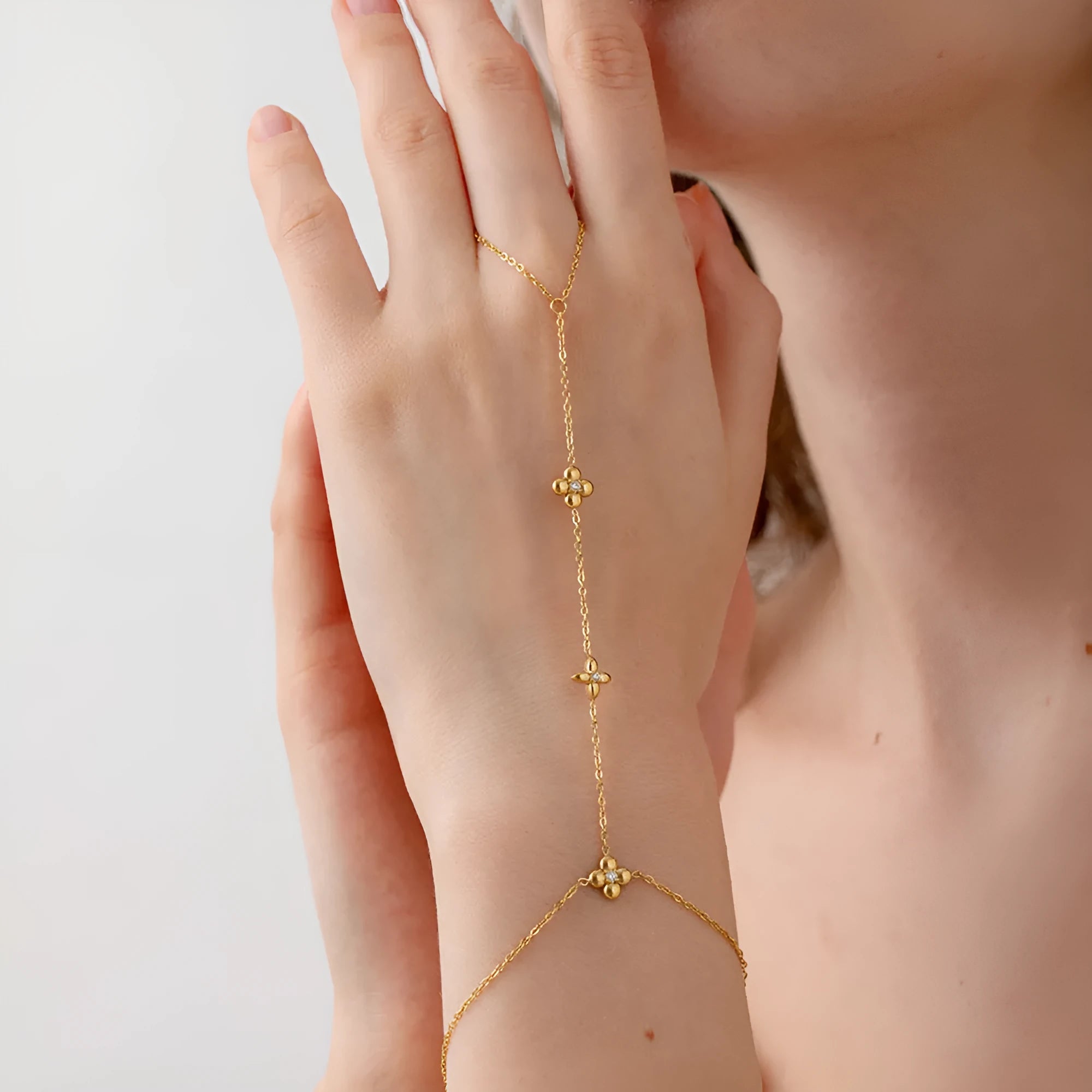 Gold-coloured stainless steel women's bracelet with geometric floral and eight-pointed star design.
