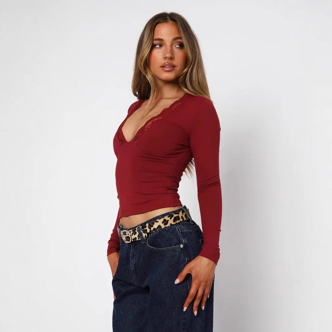 Women's slim fit black top with lace flower shoulder detail and long sleeves