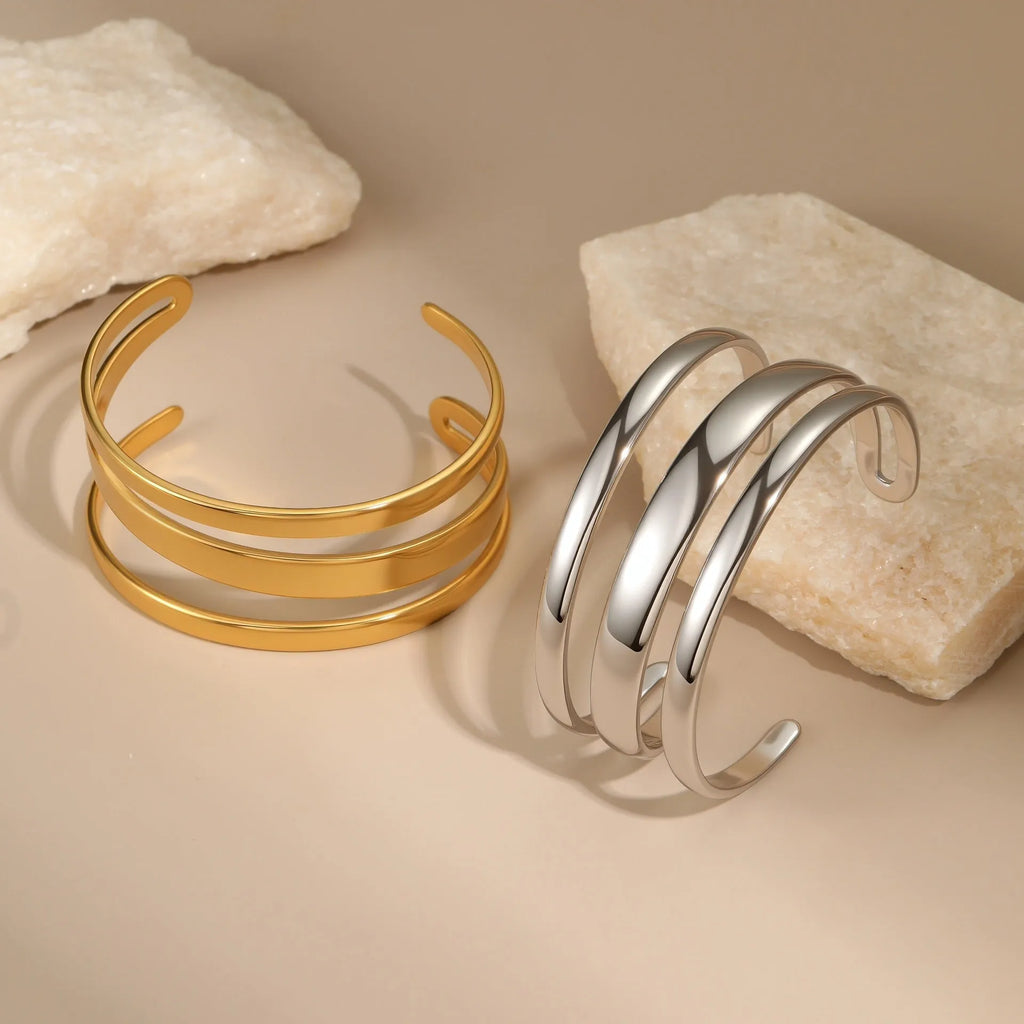Women's stainless steel simple opening bracelet with geometric line design in gold or steel colour.