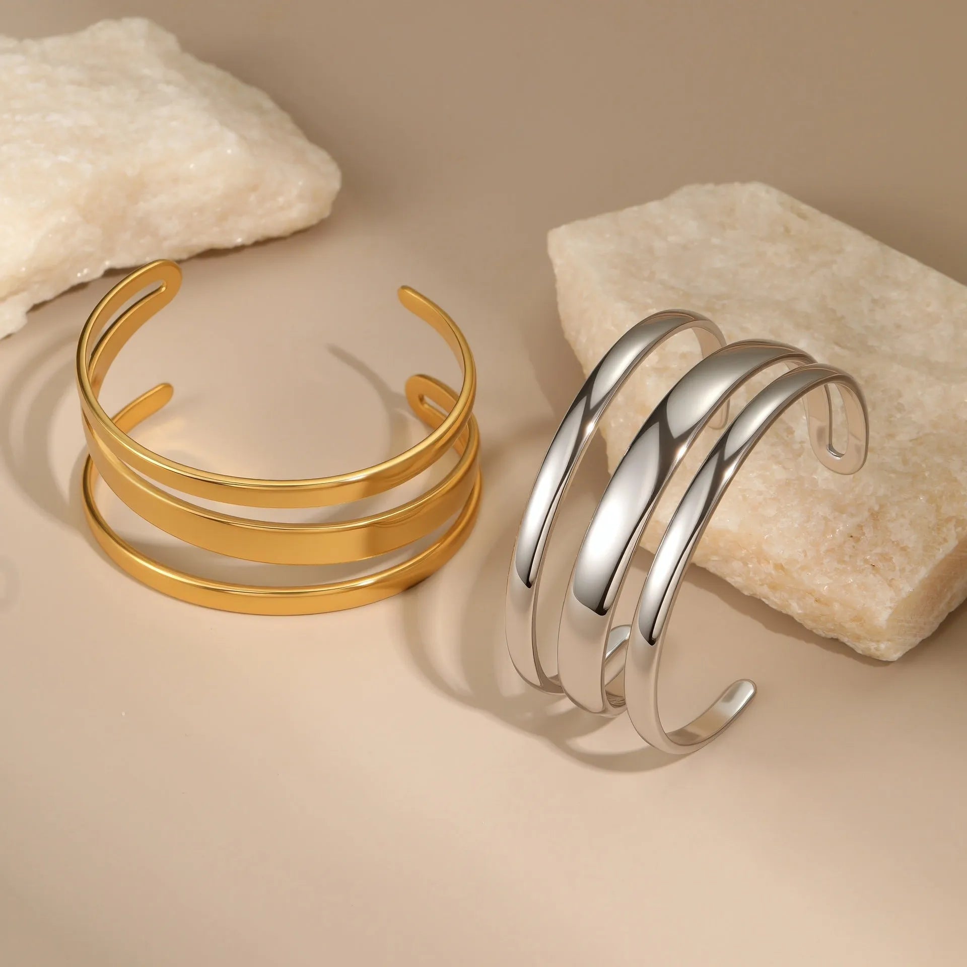 Women's stainless steel simple opening bracelet with geometric line design in gold or steel colour.
