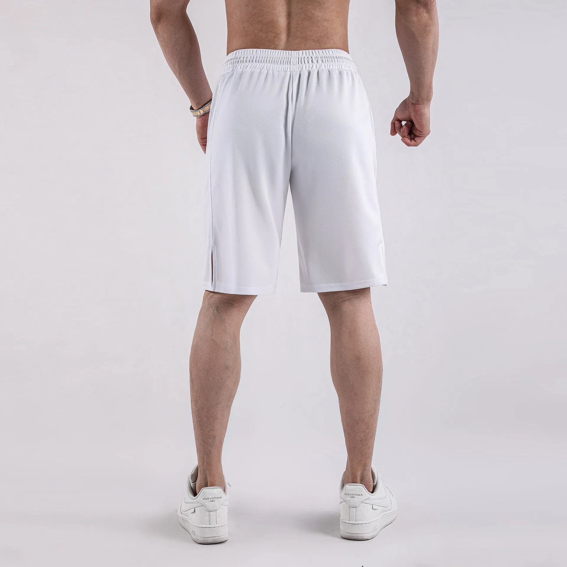 Men's black quick-drying mesh shorts in a loose capri length with elastic waistband.