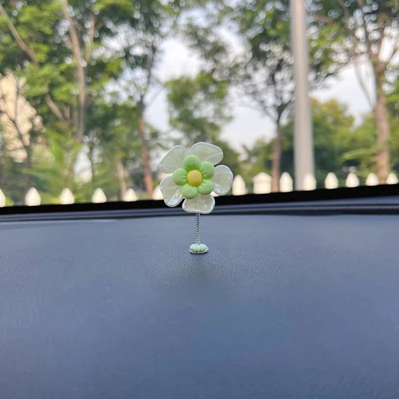 Coloured plastic car decoration swing ornament measuring approximately 5cm by 3.5cm