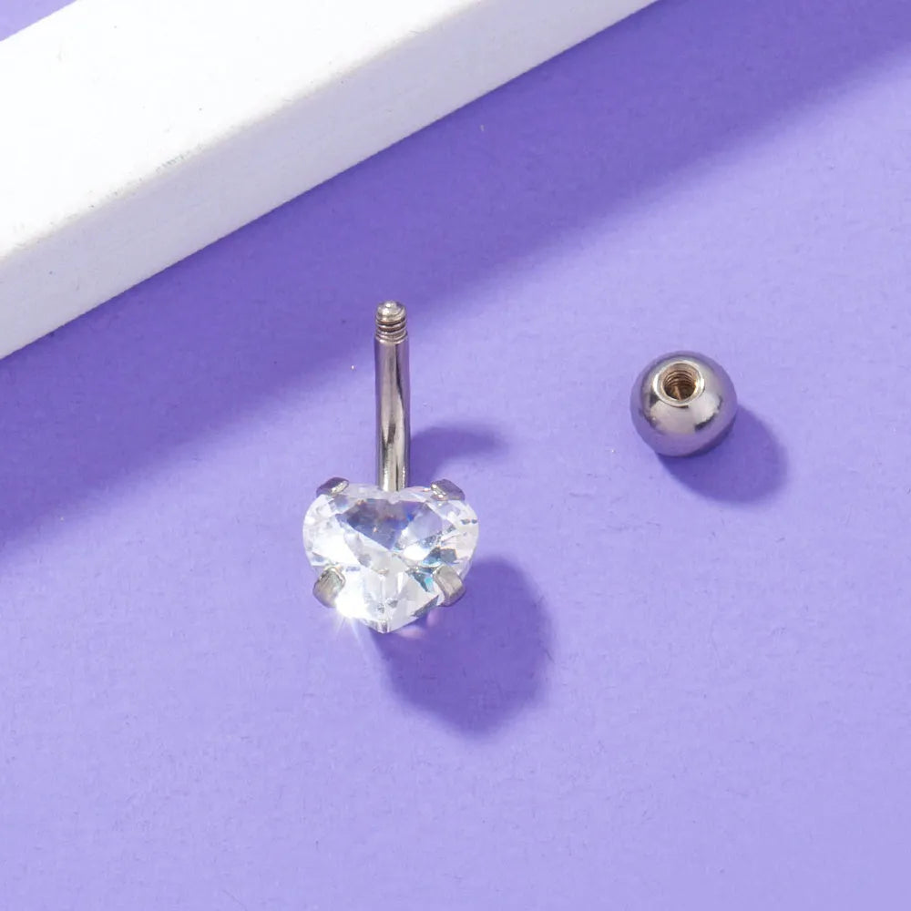 Stainless steel heart-shaped zircon navel pin, 0.8 cm wide and 1.8 cm tall, on white background