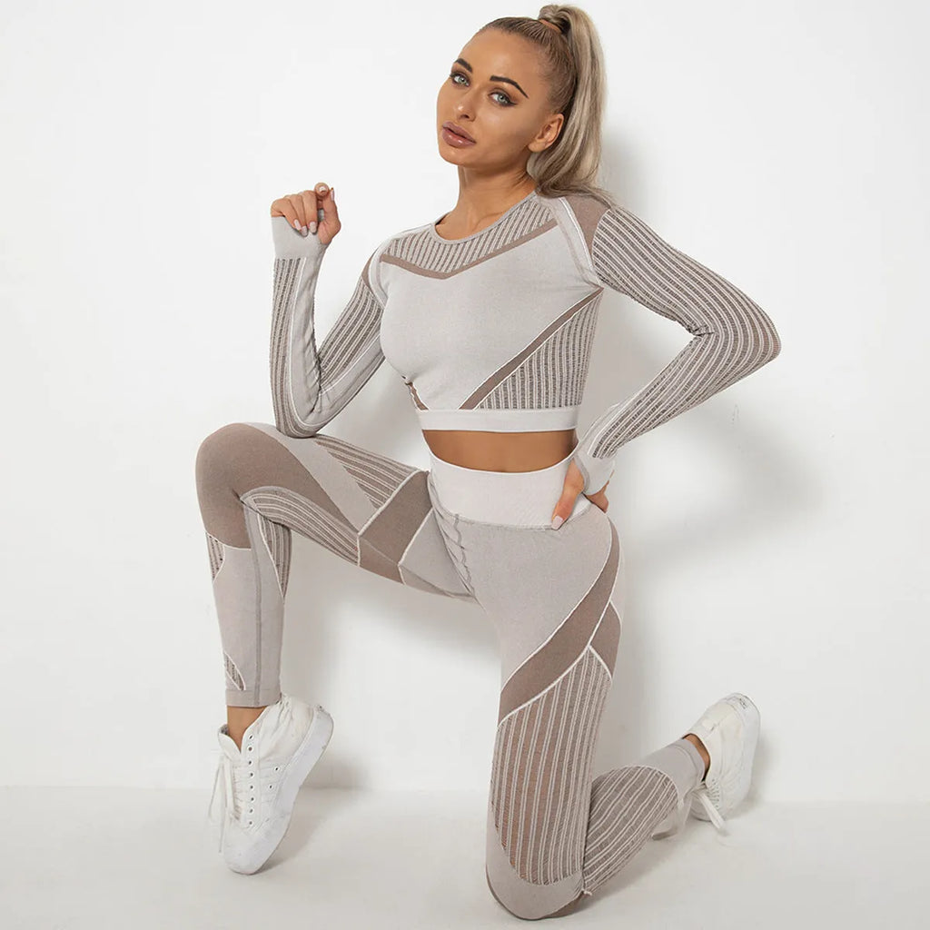 Woman wearing a seamless long-sleeved yoga suit in a neutral colour, demonstrating a stretch pose.