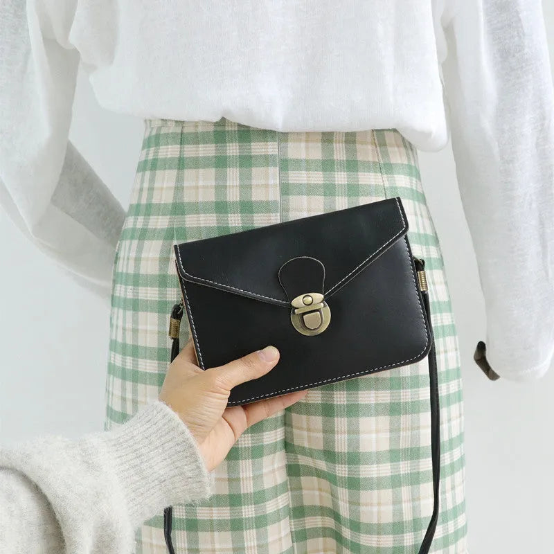 Retro messenger bag in wine red with flap closure and crossbody strap shown alongside black and light brown colour options