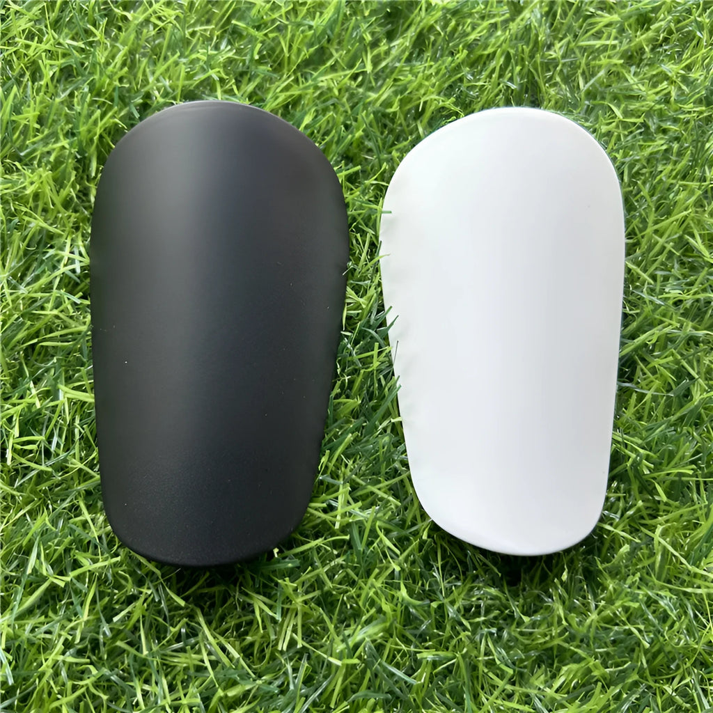 Black and white extra small plastic football shin guards for junior players