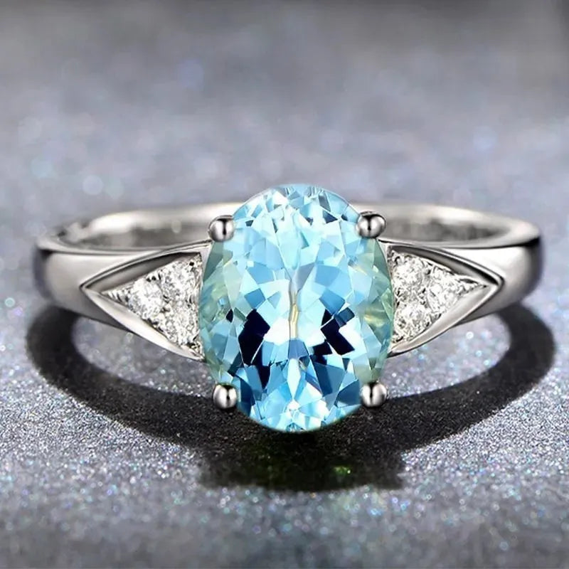 Women's court style ring with a natural zircon inlay showing heart, water drop, and bell pattern options in blue, red, green, and light blue.