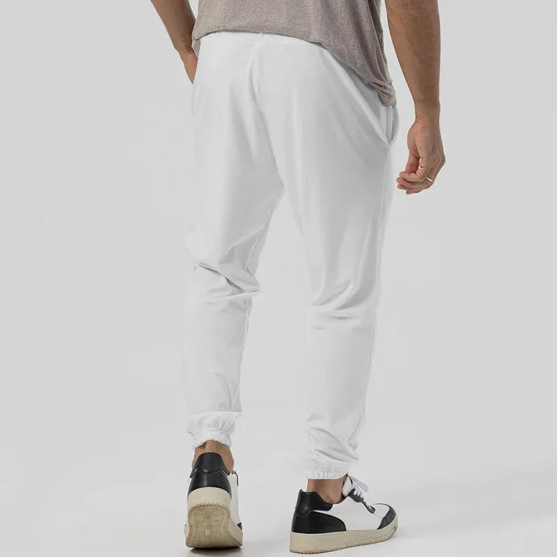 Men's grey elastic track sweatpants with tapered straight-leg design and elastic waistband