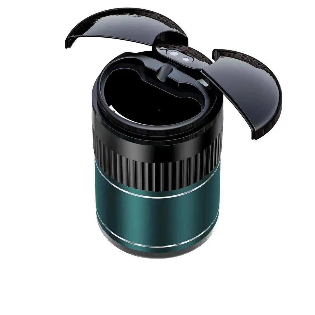 Smart black metal car ashtray with lid, showing compact size next to a charging cable.