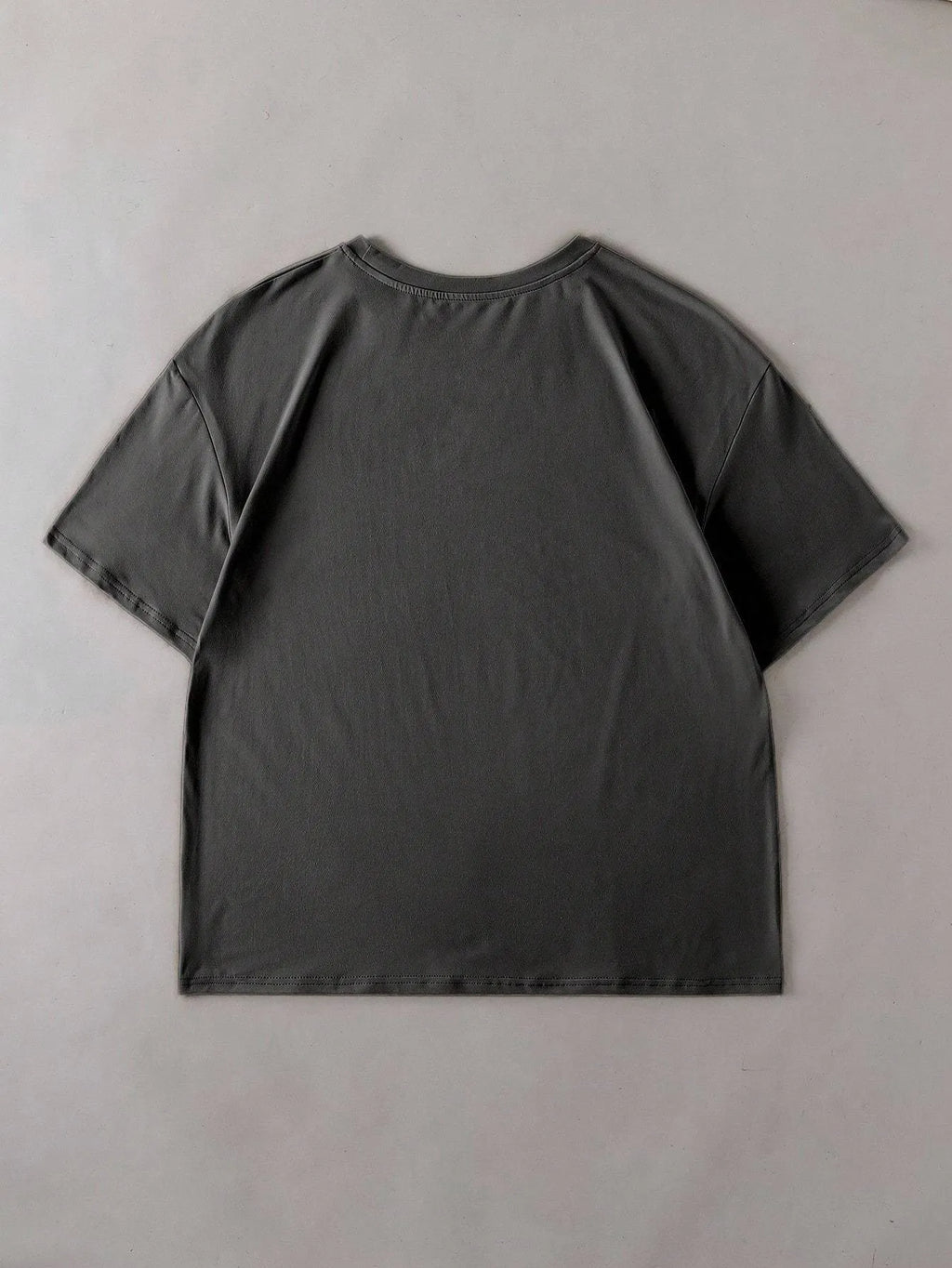 Loose fit cotton short sleeve t-shirt in black, shown on a hanger with round neck and straight cut.