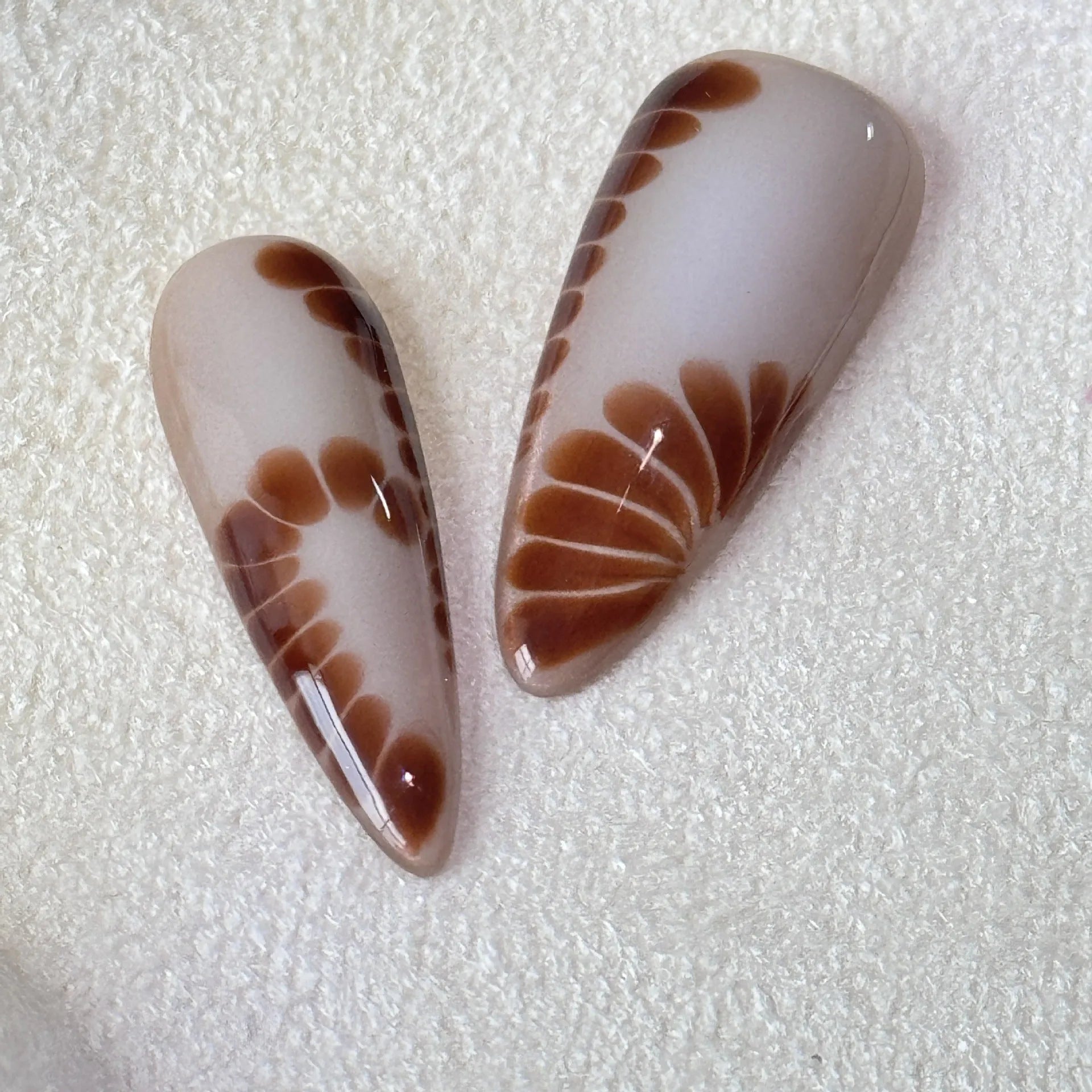 Handmade leopard print false eyelashes with cross and flower details on nail stickers.