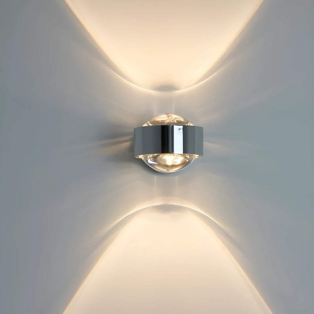 Modern small wall lamp in chrome finish for bedside or hallway lighting