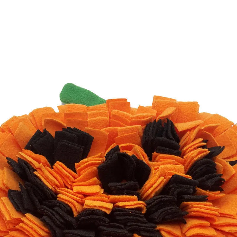 Orange pumpkin-shaped dog sniffing mat with a textured fur surface for slow feeding.